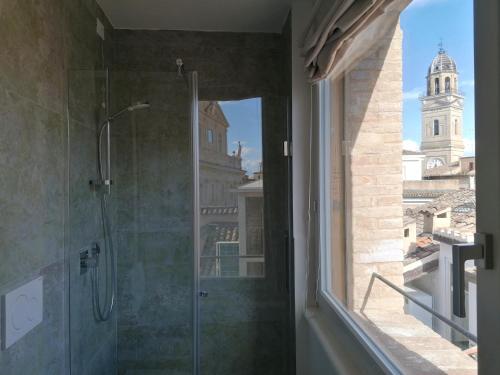 a bathroom with a shower with a view of a building at Palazzo Cortesi in Macerata