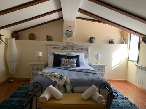 a bedroom with a bed and two night stands at Casa Rural La Joya in Candeleda