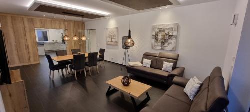 a living room with a couch and a table at Upland View in Willingen