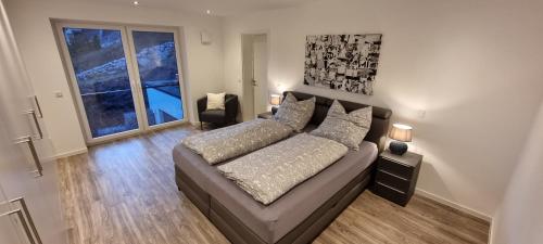 a living room with a couch and a large window at Upland View in Willingen