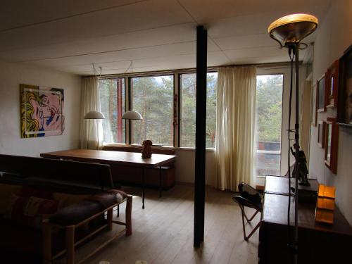 a living room with a table and a large window at Chalet Vicino a Cortina in Borca di Cadore