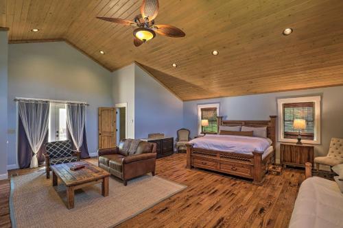 a bedroom with a bed and a ceiling fan at Game Room, Theater and Deck Burnsville Cabin! in Burnsville