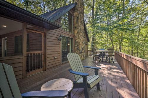 a deck with chairs and tables on a cabin at Cacapon River Cabin with Private River Access! in Great Cacapon