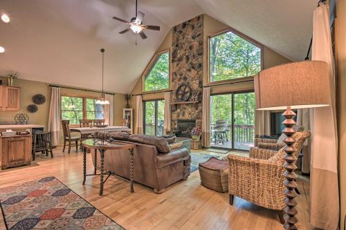a living room with a couch and a table at Cacapon River Cabin with Private River Access! in Great Cacapon