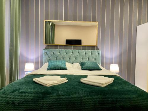a bedroom with a bed with two towels on it at Hedone Luxury 3 Apartments with FREE PARKING in Pula