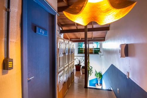 a hallway with a large yellow light hanging from the ceiling at Sea Wolf Surf Hostel in Florianópolis