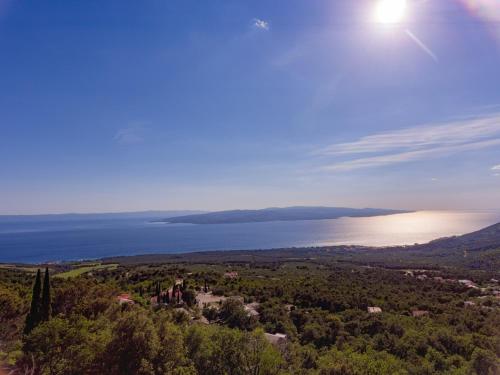 an aerial view of a large body of water at stone house Nikolina with heated Pool in Bast