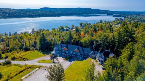 an aerial view of a large house on a hill next to a lake at Au Sommet du Lac Magog in Magog-Orford