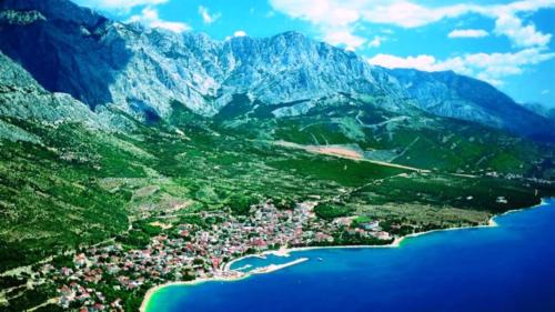 an aerial view of a small town on a mountain at stone house Nikolina with heated Pool in Bast