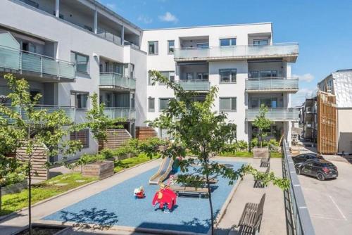 an apartment complex with a pool in front of a building at City Apartment Fully Furnished - Lillestrøm-Strømmen in Lillestrøm