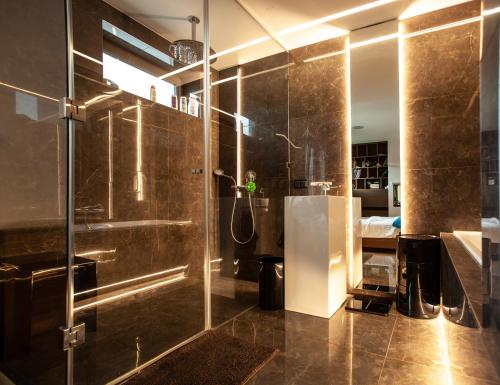 a bathroom with a shower with a glass door at Contemporary apartment with fireplace & terrace in Banská Bystrica