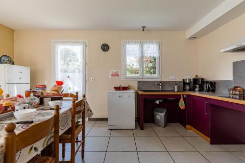 a kitchen with a table and a counter top at Les 3 Edelweiss - GITE 1 OU GITE 2 in Arette