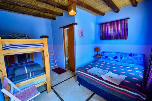 a bedroom with blue walls and a bunk bed at Tilcara Rustica Hostel in Tilcara