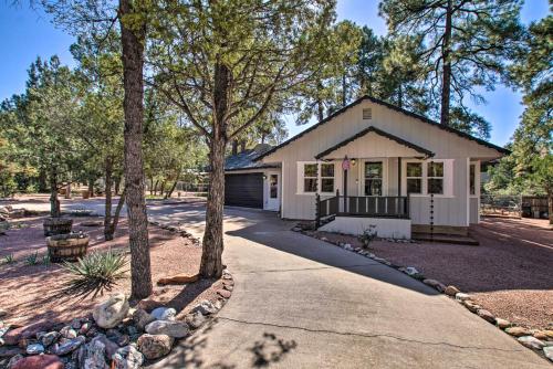 a house with trees in front of a driveway at Peaceful Deck and Fire Pit Payson Home! in Payson