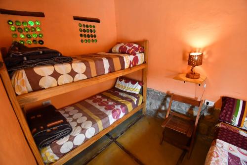 a room with two bunk beds and a lamp at Tilcara Rustica Hostel in Tilcara