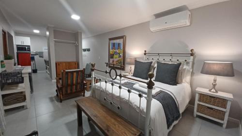 a bedroom with a bed and a table with a lamp at Gazelle Estate in Kakamas