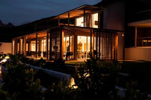 a house with a lot of windows and lights at Clouds Estate in Stellenbosch