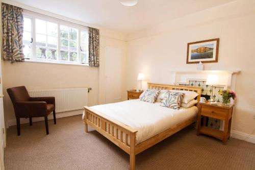 a bedroom with a bed and a desk and a chair at Rydal Hall Christian Retreat Centre in Rydal