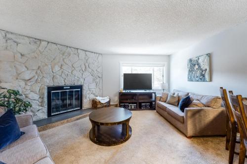 a living room with a couch and a fireplace at Sawmill Creek 216 in Breckenridge