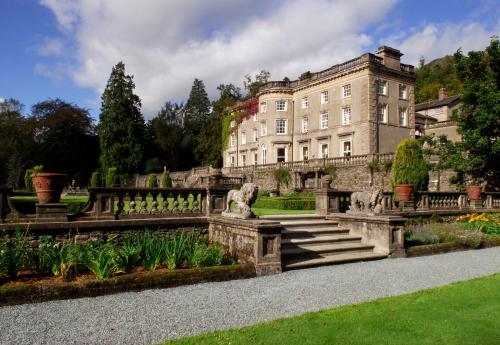 a building with a staircase in front of a garden at Rydal Hall Christian Retreat Centre in Rydal