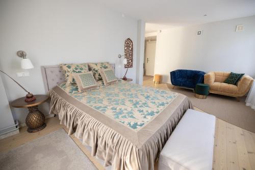 a bedroom with a large bed and a couch at Baltic Sea Dunes Apartments in Jūrmala