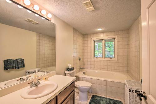a bathroom with a tub and a sink and a toilet at Charming Jackson Mountain Retreat on Golf Course! in Jackson