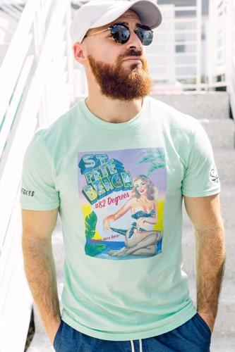 a man wearing a green shirt with a beard and sunglasses at The Saint Hotel in St Pete Beach