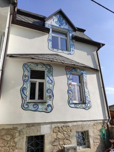 two windows on a house with colorful tiles at art-house 4 Attic Apartment in Děčín