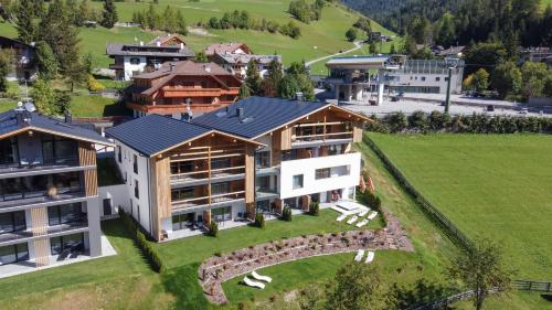 an aerial view of a large house with a yard at CHALET NORA in San Vigilio Di Marebbe