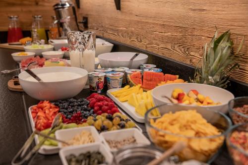 a table with many different types of food on it at CHALET NORA in San Vigilio Di Marebbe