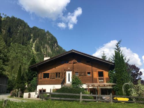 a large wooden house in the middle of a mountain at Haus Riverside in Zaunhof