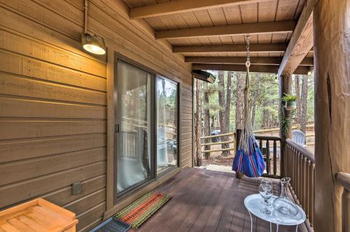a porch with a swing and a hammock on a house at Trail Access Pet-Friendly Cabin in Show Low! in Show Low