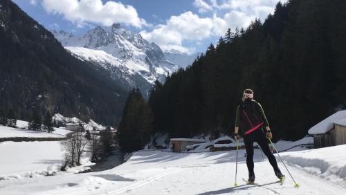 a man is standing on skis in the snow at Haus Riverside in Zaunhof