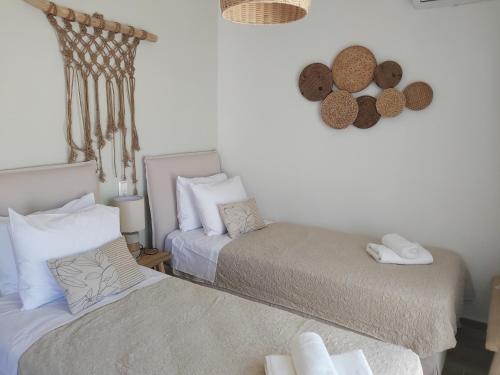 a bedroom with two beds and a mirror on the wall at Palazzino d Irene in Rethymno Town