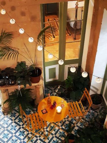 a room with a table and chairs on the floor at Myrtle Suite - Authentic Valletta Experience in Valletta
