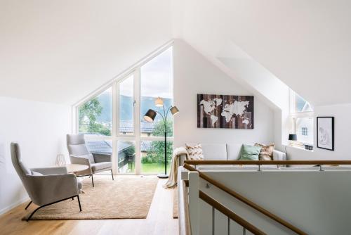 a living room with white walls and a large window at Modern Villas in Plush town in Tromsø