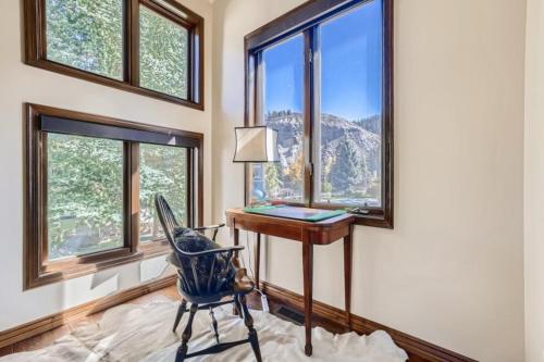 a desk with a chair in a room with windows at 10 N Fairway Drive in Beaver Creek