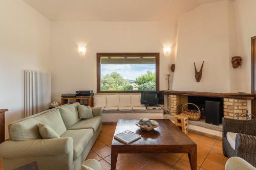 a living room with a couch and a table at Villa Anna Maria in Villasimius