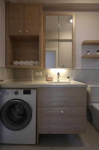 a bathroom with a washing machine and a sink at Çiğdem'inn Sığacık (Cigdeminn Sigacik) in Siğacık
