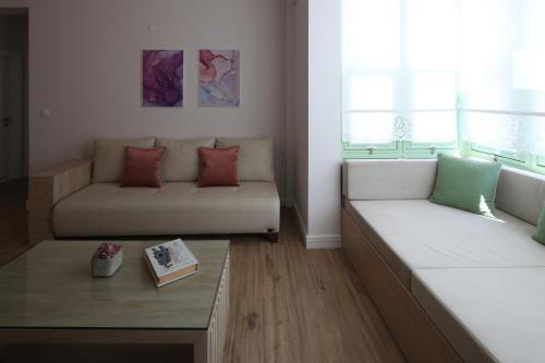 a living room with two couches and a coffee table at Çiğdem'inn Sığacık (Cigdeminn Sigacik) in Siğacık