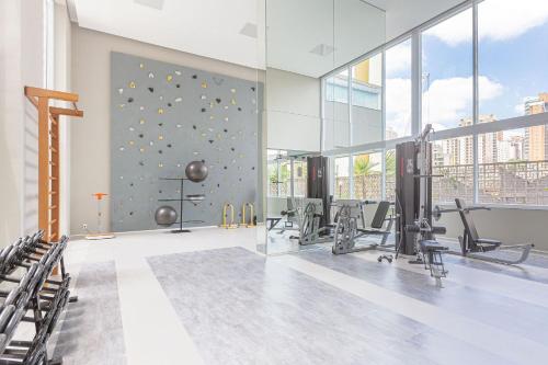 a gym with a climbing wall in a building at Vossa Bossa VN Turiassu in São Paulo