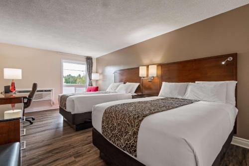 A bed or beds in a room at SureStay Hotel by Best Western Kemptville
