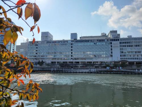 a large building next to a body of water at Hotel Osaka Castle in Osaka
