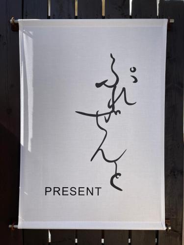 a sign that says present on a wall at ゲストハウスぷれぜんと in Tokyo