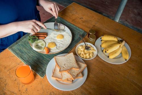 a table with plates of breakfast food on it at Wild Wadi Wilpattu - Villas with private Plunge Pools in Wilpattu