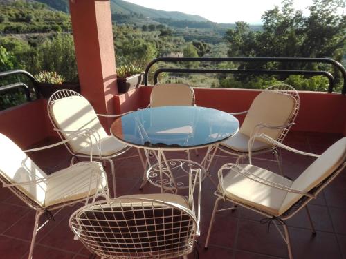 a table and chairs on a balcony with a view at Full rental or by areas. Barbecue, Gardens, Large Terraces, Three rooms in Beniatjar