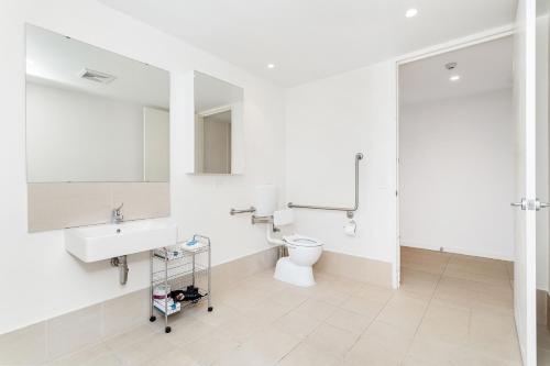 a bathroom with a sink, toilet and bathtub at Nautica Residences Fremantle in Fremantle
