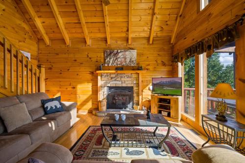 a living room with a couch and a fireplace at Peaks of Blue with Hot Tub and Theater Room in Sevierville