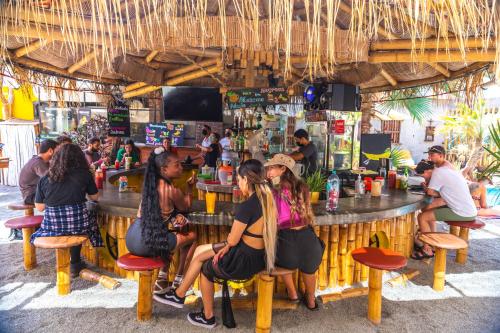 a group of people sitting at a bar at Banana's Adventure Hostel in Ica