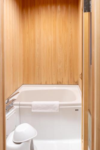 a bathroom with a toilet and a bath tub at Little Hotel Kyoto Karasuma Takatsuji in Kyoto
